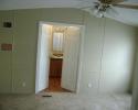 freshly painted bedroom in mobile home with new bathroom doors