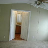 freshly painted bedroom in mobile home with new bathroom doors
